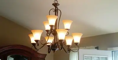 Classic ceiling chandelier installation with warm lighting in Milwaukee, WI