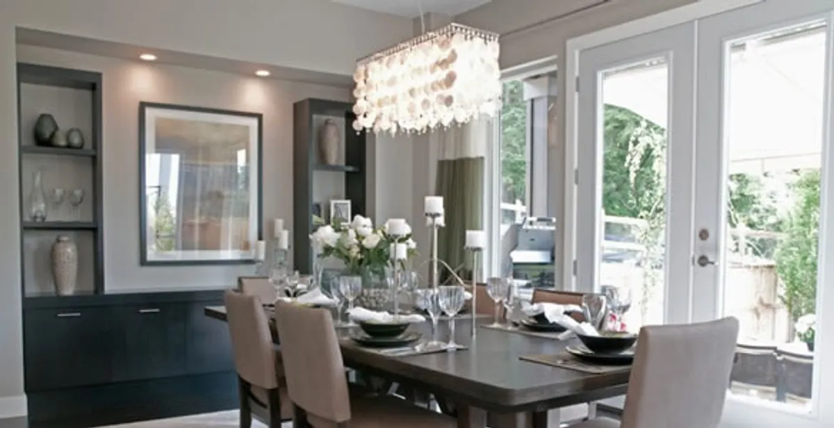 Elegant dining room chandelier installation above table in Milwaukee, WI