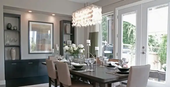 Elegant dining room chandelier installation above table in Milwaukee, WI