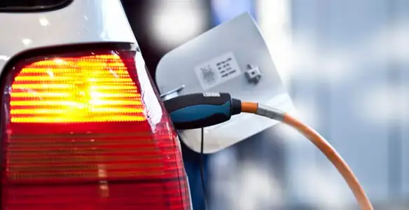 Electric car plugged into EV charger after professional installation in Milwaukee, WI