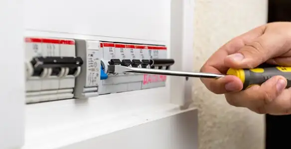electrical panel upgrade service showing technician adjusting circuit breakers during system upgrade in Milwaukee, WI