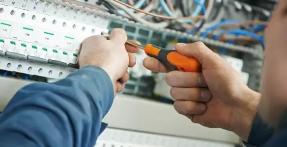 electrical service showing licensed electrician performing electrical panel maintenance and adjustments in Milwaukee, WI