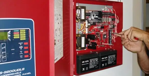 fire alarm installation service showing technician configuring fire alarm control panel in Milwaukee, WI