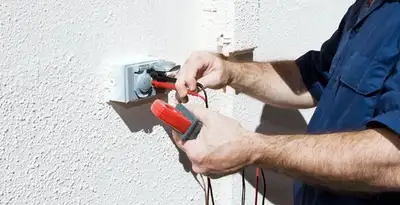 Electrician performing home electrical outlet and wiring inspection in Milwaukee, WI