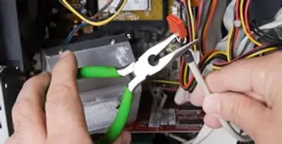 Licensed electrical contractor performing electrical repair with tools in Cudahy, WI