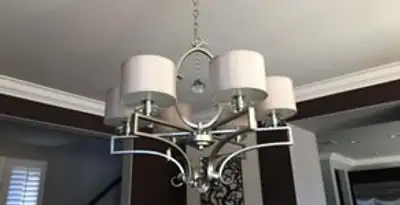 Modern chandelier installation with multiple light fixtures in Milwaukee, WI