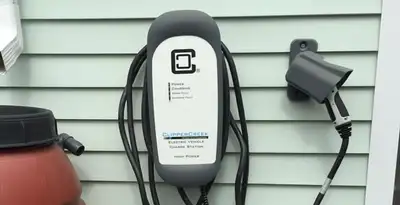 Outdoor electric vehicle charger installation on residential wall in Milwaukee, WI
