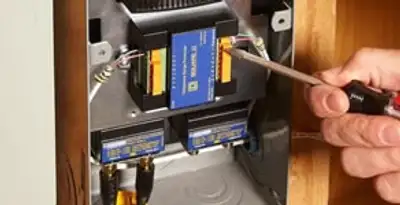 Whole home surge protection device being installed by a licensed electrician to protect electrical systems in Milwaukee, WI